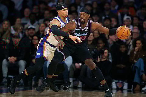 New York Knicks guard Josh Hart, left, defends Miami Heat center Bam Adebayo, right, during the first half of an NBA basketball game in New York.