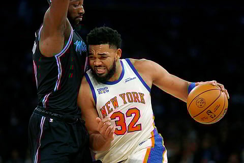 Miami Heat center Bam Adebayo, left, defends against New York Knicks center Karl-Anthony Towns, right, during the first half of an NBA basketball game in New York. 