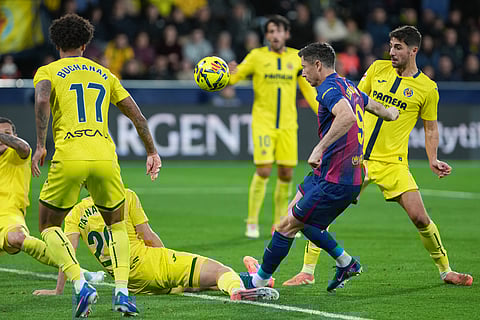 Barcelona's Robert Lewandowski tries a shot during the Spanish La Liga soccer match between Villarreal and Barcelona in Villarreal, Spain.