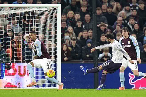 Manchester United's Bruno Fernandes, second right, attempts a shot towards goal during the Premier League soccer match between Aston Villa and Manchester United, in Birmingham, England.