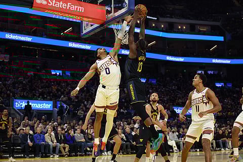 Golden State Warriors forward Jimmy Butler III (10) goes up to dunk against Phoenix Suns forward Ryan Dunn (0) during the second half of an NBA basketball game in San Francisco.