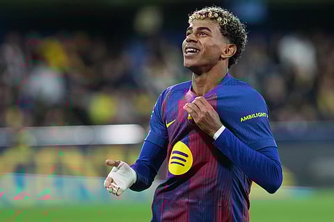 Barcelona's Lamine Yamal celebrates after scoring his side's second goal during the Spanish La Liga soccer match between Villarreal and Barcelona in Villarreal, Spain.