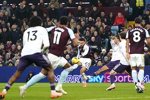 Aston Villa's Morgan Rogers, centre, scores their side's first goal of the game during the Premier League soccer match between Aston Villa and Manchester United, in Birmingham, England.