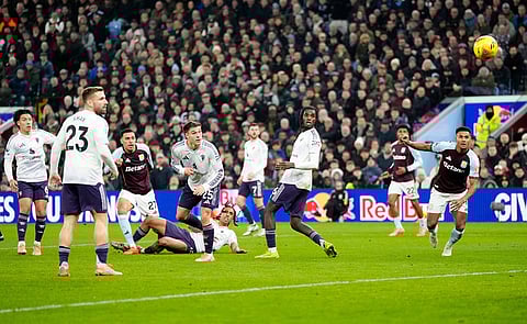 Aston Villa's Morgan Rogers, third left, scores their side's second goal of the game during the Premier League soccer match between Aston Villa and Manchester United, in Birmingham, England.