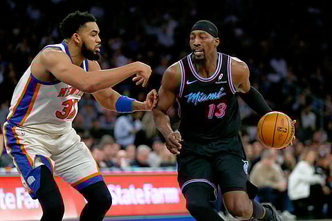 New York Knicks center Karl-Anthony Towns, left, defends against Miami Heat center Bam Adebayo, right, during the second half of an NBA basketball game in New York. 