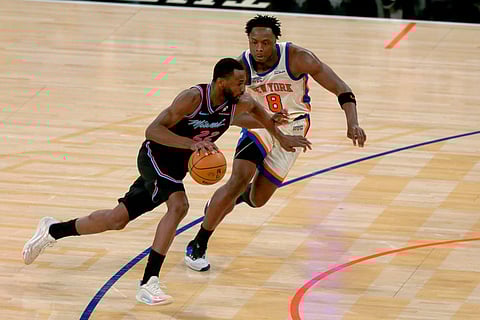 Miami Heat forward Andrew Wiggins, left, dribbles past New York Knicks OG Anunoby, right, during the second half of an NBA basketball game in New York. 