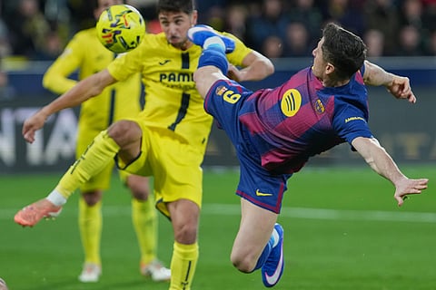 Barcelona's Robert Lewandowski tries a shot during the Spanish La Liga soccer match between Villarreal and Barcelona in Villarreal, Spain.