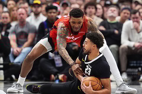 Houston Rockets forward Jabari Smith Jr., back, covers after Denver Nuggets forward Cameron Johnson collects a loose ball in the second half of an NBA basketball game in Denver. 
