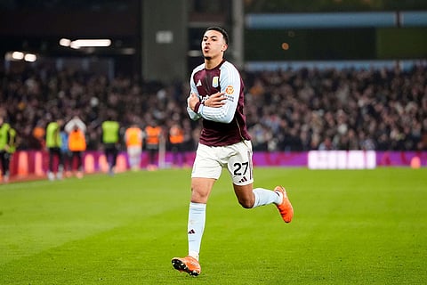 Aston Villa's Morgan Rogers celebrates after scoring their side's second goal of the game during the Premier League soccer match between Aston Villa and Manchester United, in Birmingham, England.