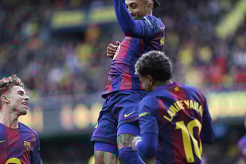 Barcelona's Raphinha celebrates after scoring the opening goal from a penalty kick during the Spanish La Liga soccer match between Villarreal and Barcelona in Villarreal, Spain.