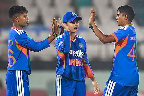India's Kranti Gaud, left, with teammates Vaishnavi Sharma, center, and Shree Charani during the first Women's T20I cricket match between India and Sri Lanka, in Visakhapatnam, Andhra Pradesh.