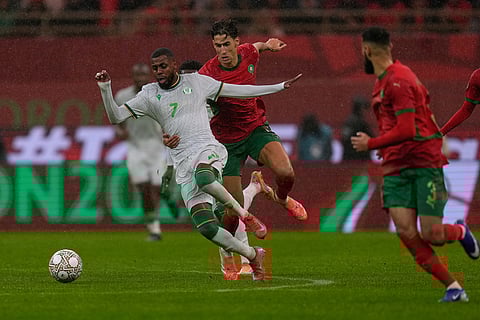 Morocco's Nayef Aguerd holds Comoros' Faiz Selemani during the Africa Cup of Nations group A soccer match between Morocco and Comoros in Rabat, Morocco.