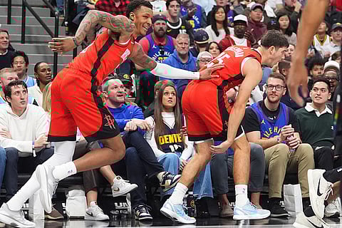 Houston Rockets forward Jabari Smith Jr., left, congratulates guard Reed Sheppard as he reacts after hitting a 3-point basket against the Denver Nuggets in the second half of an NBA basketball game in Denver. 