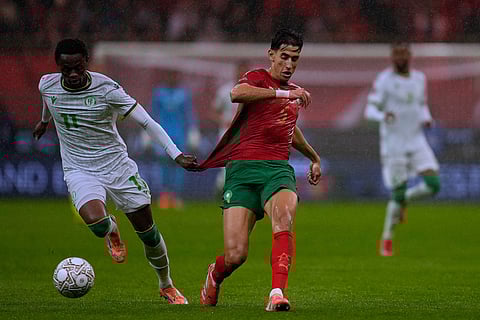 Comoros' Rafiki Saïd Ahamada pulls Morocco's Nayef Aguerd during the Africa Cup of Nations group A soccer match between Morocco and Comoros in Rabat, Morocco.