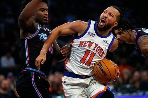 Miami Heat guard Davion Mitchell, left, defends against New York Knicks guard Jalen Brunson (11)  during the first half of an NBA basketball game in New York. 
