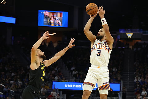 Phoenix Suns forward Dillon Brooks (3) looks to shoot against Golden State Warriors guard Stephen Curry, left, during the first half of an NBA basketball game in San Francisco.