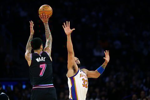 Miami Heat center Kel'el Ware (7) looks to shoot over New York Knicks center Karl-Anthony Towns (32) during the first half of an NBA basketball game in New York. 