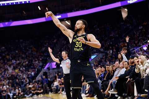 Golden State Warriors guard Stephen Curry (30) attempts a three-pointer against the Phoenix Suns in the first half during an NBA basketball game in San Francisco.