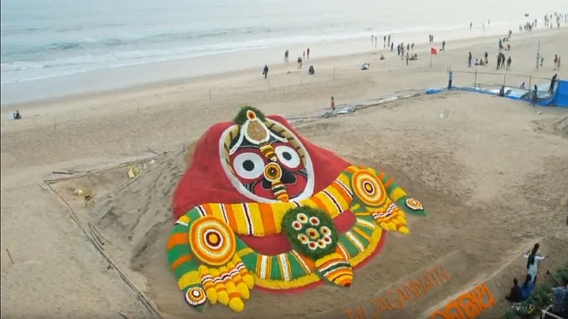 Colorful sand art of Lord Jagannath on an Odisha beach near the sea