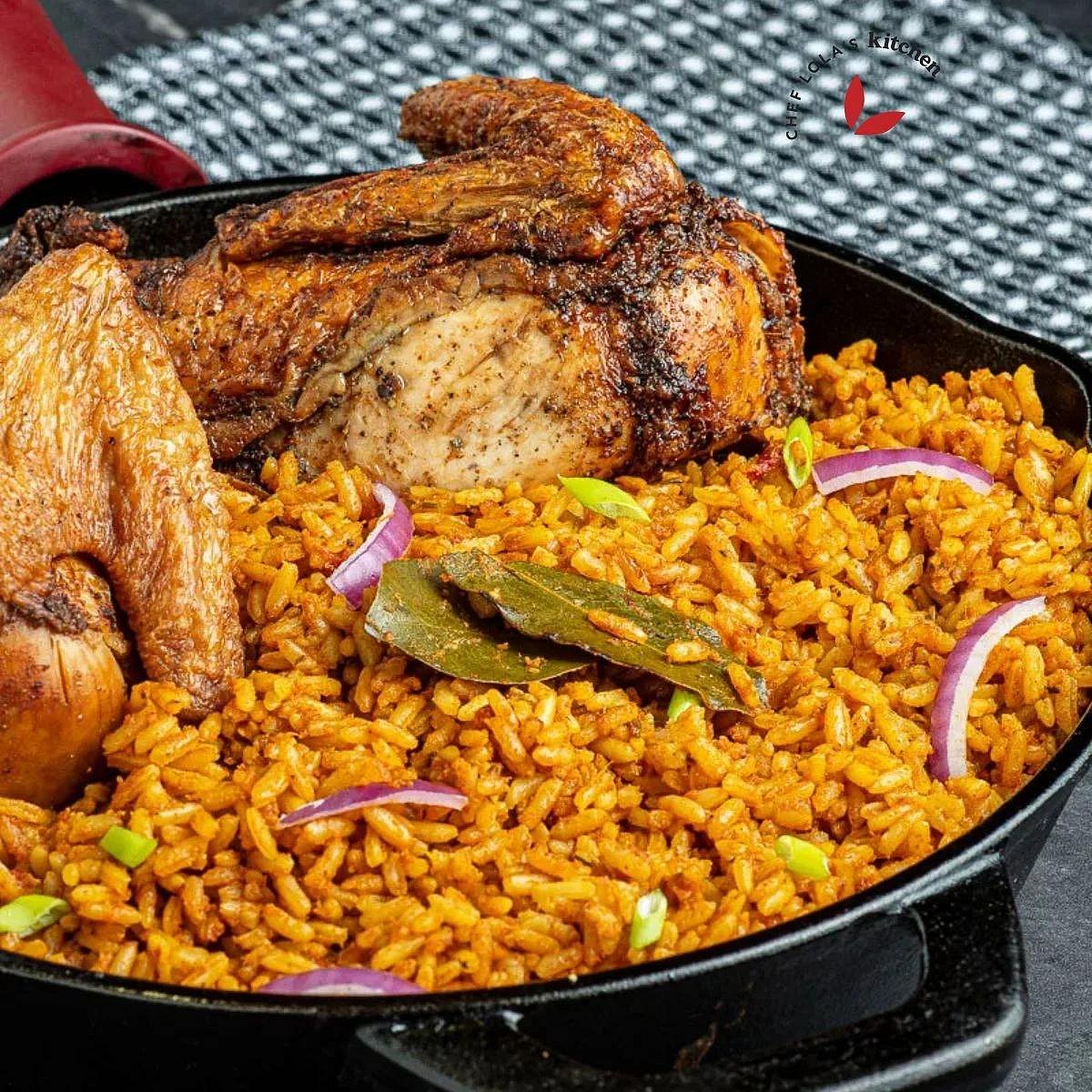 Jollof rice and roasted chicken served in a black cast iron skillet