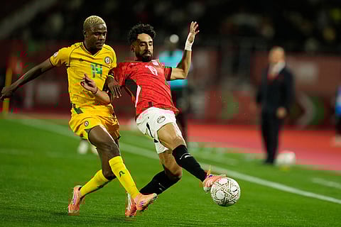 Zimbabwe's Daniel Msendami, left, and Egypt's Mostafa Fathy fight for the ball during the Africa Cup of Nations group B soccer match between Egypt and Zimbabwe in Agadir, Morocco.