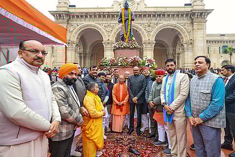 Uttar Pradesh Chief Minister Yogi Adityanath, centre, during the 'Kisan Diwas' program on the birth anniversary of former Prime Minister Chaudhary Charan Singh, in Lucknow.