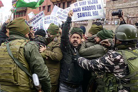 Security personnel try to stop Congress workers as they protest over the hijab controversy involving Bihar Chief Minister Nitish Kumar, in Srinagar.