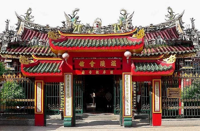 The entrance of a traditional Chinese pagoda in Saigons Cho Lon area with ornate roof carvings