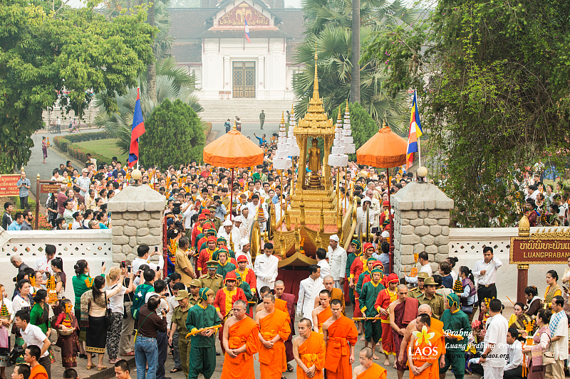Buddhist procession with monks and golden chariot in Luang Prabang