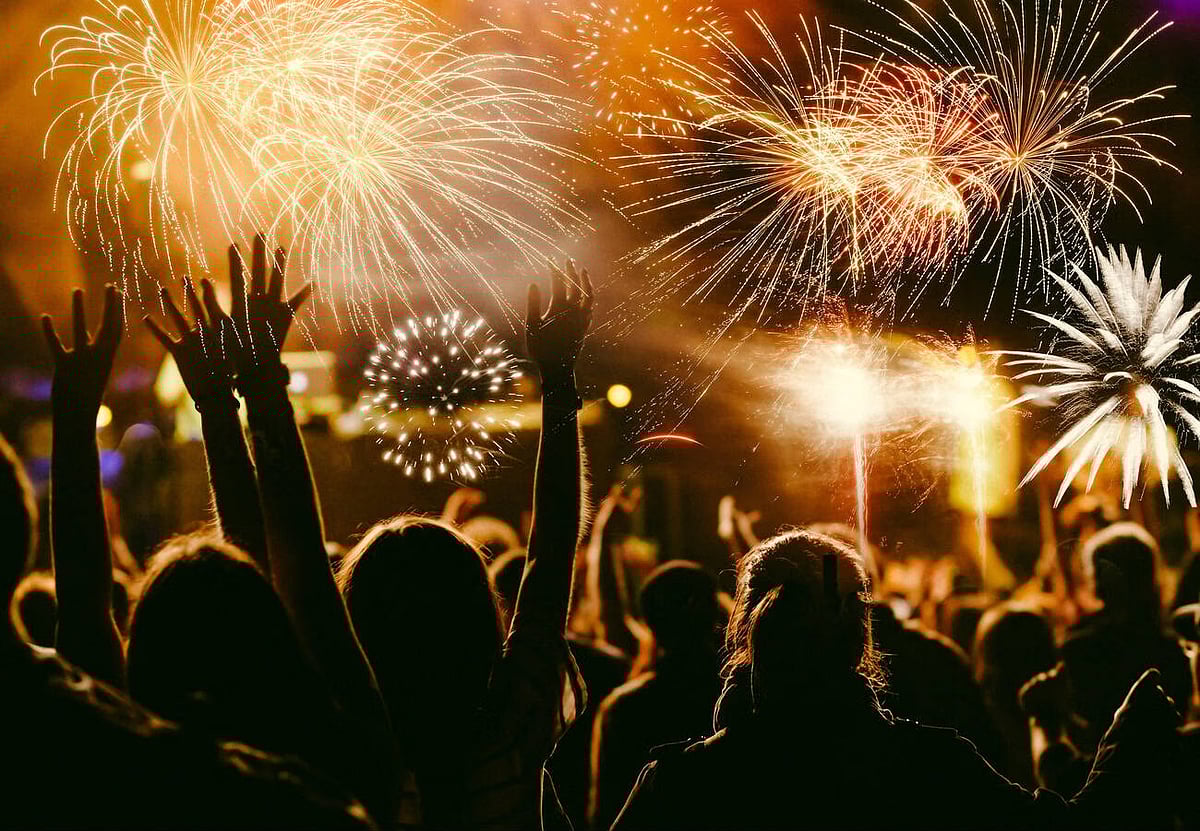 Crowd celebrating New Year with fireworks