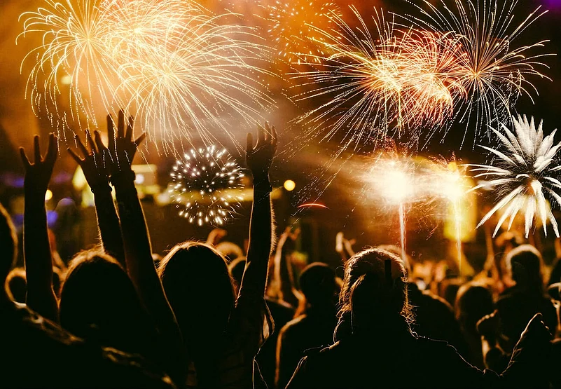 Crowd celebrating New Year with fireworks