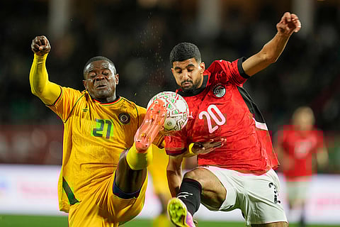 Zimbabwe's Godknows Murwira, left, and Egypt's Ibrahim Adel fight for the ball during the Africa Cup of Nations group B soccer match between Egypt and Zimbabwe in Agadir, Morocco.