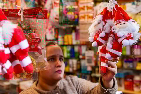 A woman shops for decorative items ahead of the Christmas festival at the Lower Bazar, in Shimla.