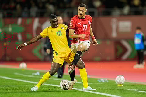 Zimbabwe's Marvelous Nakamba, left, and Egypt's Mostafa Mohamed fight for the ball during the Africa Cup of Nations group B soccer match between Egypt and Zimbabwe in Agadir, Morocco.