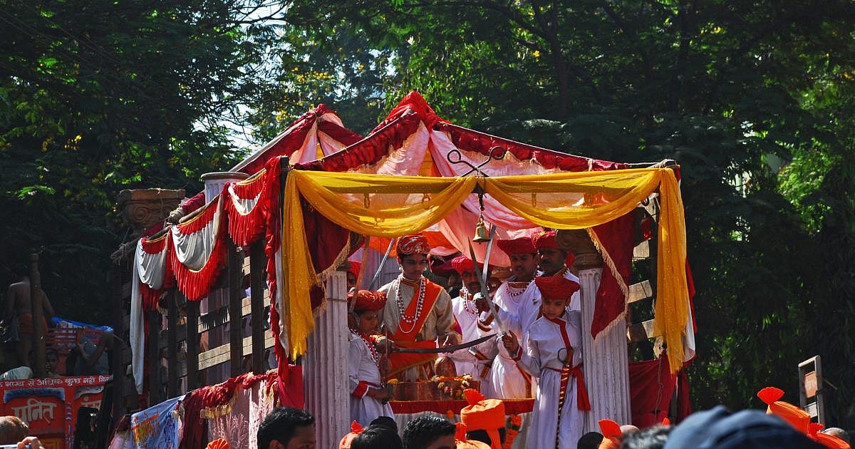 Decorated Gudi Padwa festival float with people in traditional attire