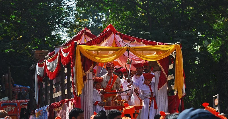 Decorated Gudi Padwa festival float with people in traditional attire