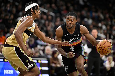 San Antonio Spurs guard De'Aaron Fox, right, drives to the basket against Washington Wizards guard Tre Johnson, left, during the second half of an NBA basketball game in Washington. 