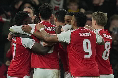 Arsenal players celebrate after a goal during the English Football League Cup quarter-final soccer match between Arsenal and Crystal Palace in London.