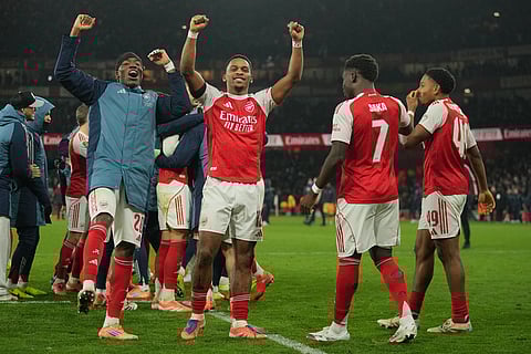 Arsenal players celebrate after winning in a penalty shootout the English Football League Cup quarter-final soccer match between Arsenal and Crystal Palace in London.