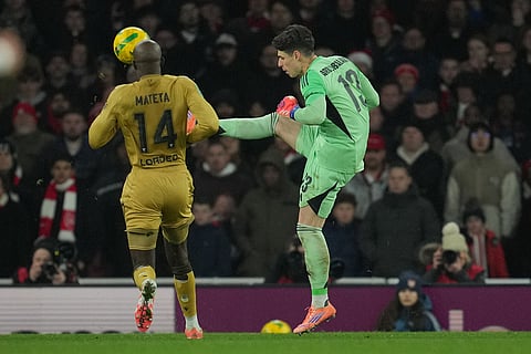 Arsenal's goalkeeper Kepa Arrizabalaga clares the ball in front of Crystal Palace's Jean-Philippe Mateta during the English Football League Cup quarter-final soccer match between Arsenal and Crystal Palace in London.