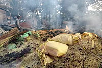 | Photo: PTI : Smoke billows out from a vandalised area following violent protests demanding eviction of encroachers from tribal belts, at Kheroni, in Karbi Anglong district, Assam.