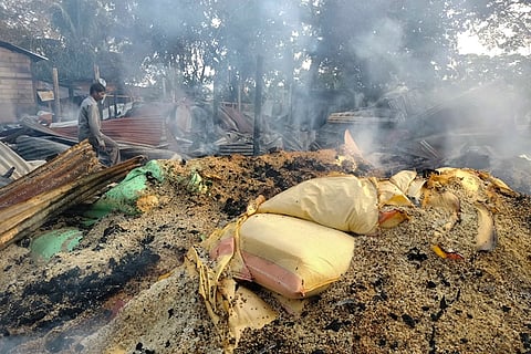Smoke billows out from a vandalised area following violent protests demanding eviction of encroachers from tribal belts, at Kheroni, in Karbi Anglong district, Assam.