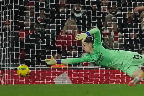 Arsenal's goalkeeper Kepa Arrizabalaga saves during the English Football League Cup quarter-final soccer match between Arsenal and Crystal Palace in London.