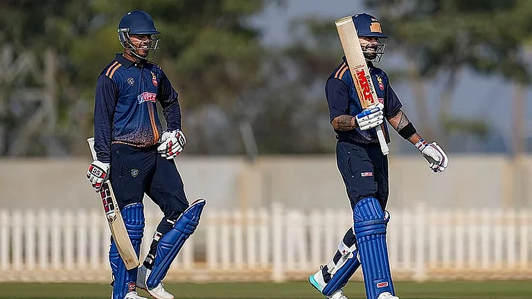 Virat Kohli, right, celebrates his century during the Vijay Hazare Trophy 2025-26 cricket match between Andhra and Delhi, at BCCI Centre of Excellence Ground, in Bengaluru. - PTI