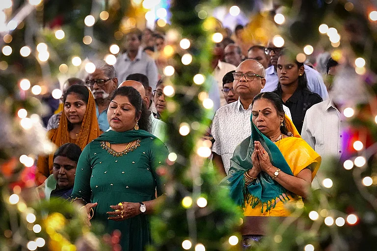 Christian devotees offer prayers during the Christmas morning service at Santhome Cathedral Basilica church, in Chennai. - | Photo: PTI/R SenthilKumar