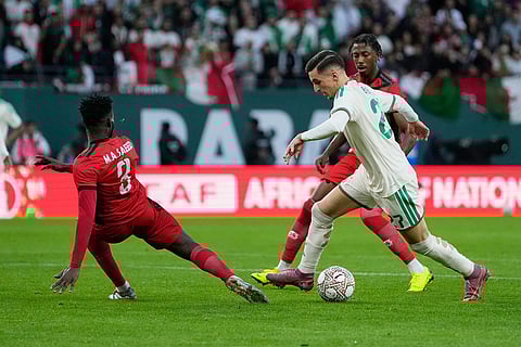 Algeria's Adil Boulbina, right, challenges for the ball with Sudan's Mohamed Saeed Ahmed during the Africa Cup of Nations group E soccer match between Algeria and Sudan in Rabat, Morocco.