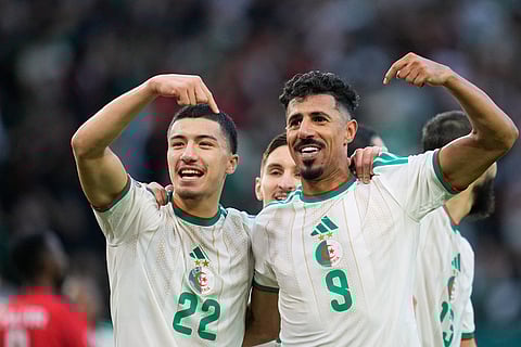 Algeria's Ibrahim Maza, left, celebrates with Algeria's Baghdad Bounedjah after scoring his side's third goal during the Africa Cup of Nations group E soccer match between Algeria and Sudan in Rabat, Morocco.