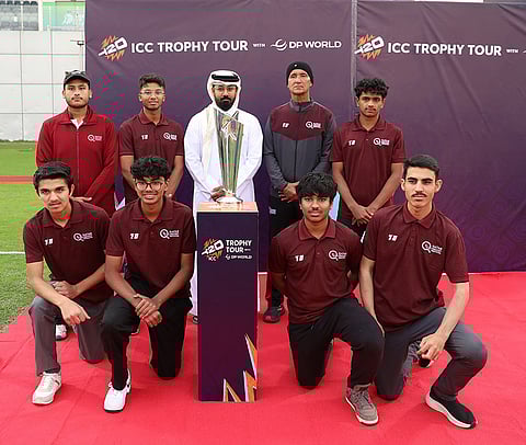Fans pose with the ICC Men’s T20 World Cup 2026 trophy at Asian Town during the trophy tour in Qatar