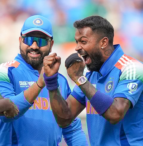 India's Hardik Pandya, right, celebrates with captain Rohit Sharma after taking the wicket of Pakistan's Saud Shakeel during a One Day International (ODI) cricket match of the ICC Champions Trophy between India and Pakistan, at Dubai International Cricket Stadium, in Dubai, UAE, Sunday, Feb. 23, 2025. 