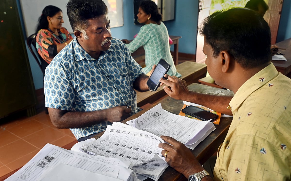  PTI                                : A Booth Level Officer (BLO) interacts with a voter as he checks and collects filled enumeration forms for the special intensive revision (SIR) of electoral rolls, in Thiruvananthapuram,